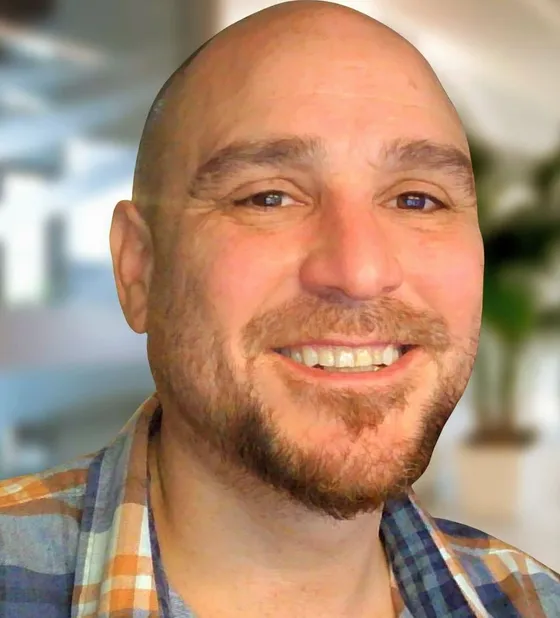Jesse Jonesberg, smiling, in a plaid shirt.